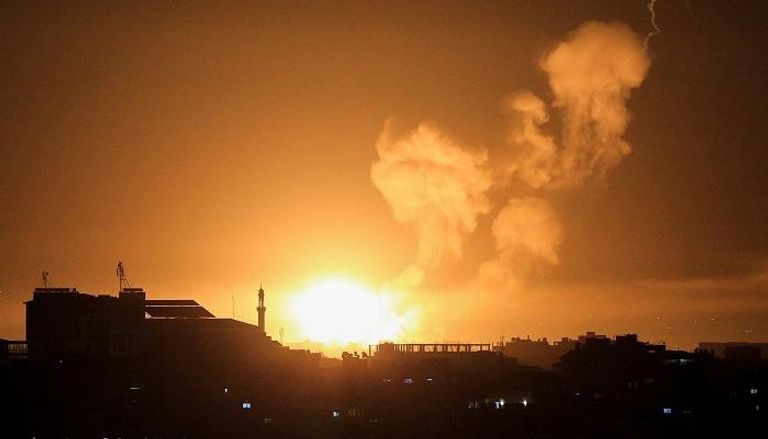 النيران تتصاعد من أحد المباني بغزة جراء القصف الإسرائيلي - رويترز