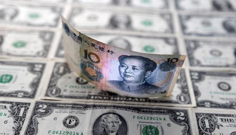 الدولار الأمريكي واليوان الصيني - رويترز