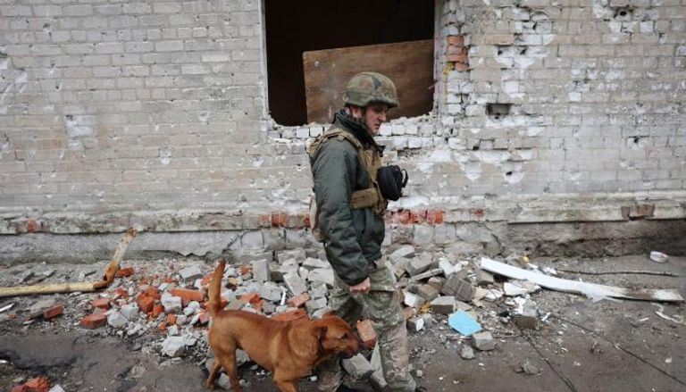 شرطي أوكراني مع كلبه في بلدة أفدييفكا