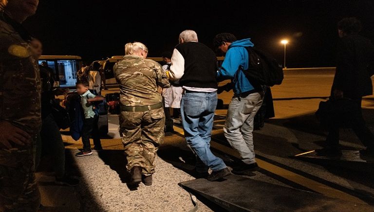 بريطانيون يسيرون باتجاه طائرة تابعة لسلاح الجو البريطاني أثناء الإجلاء إلى قبرص
