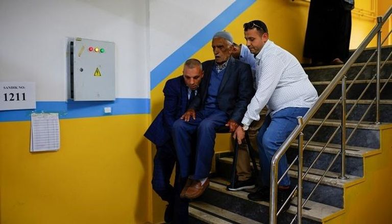ناخب مسن داخل مركز للاقتراع بتركيا - رويترز