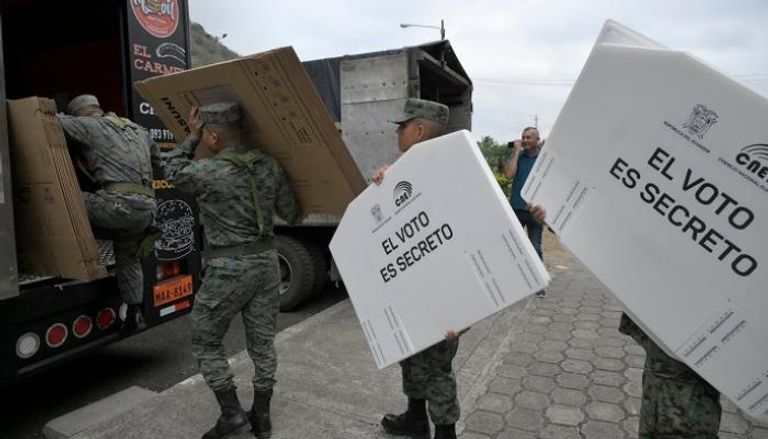 جنود بالجيش الإكوادوري ينقلون معدات الاقتراع الرئاسي