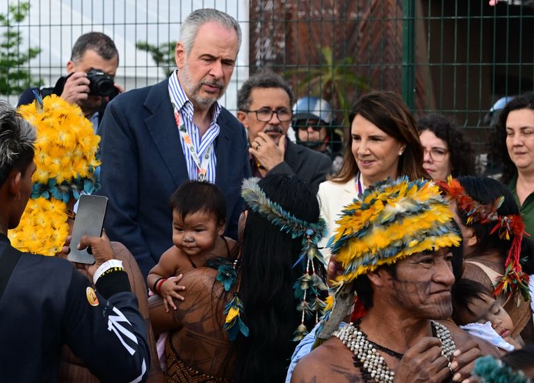 أفراد من شعب موندوروكو - أ ف ب رئيس COP30 يحمل طفل موندوروكو - أ ف ب