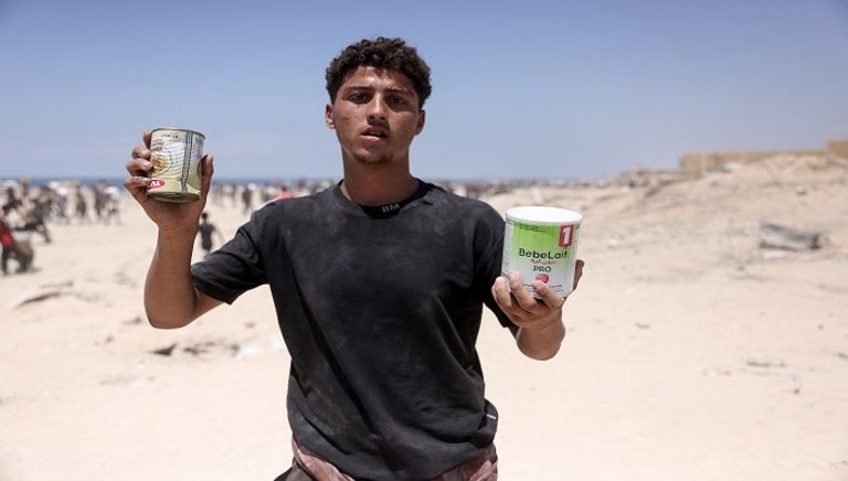 فلسطينيون يحملون أكياس الدقيق