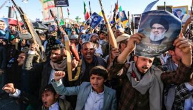 عناصر تابعة لمليشيات الحوثي ترفع صورة حسن نصر الله