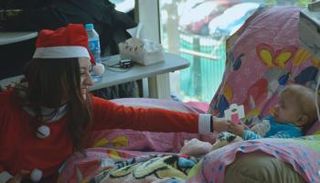 girl in santa cloas clothes plays with childrens