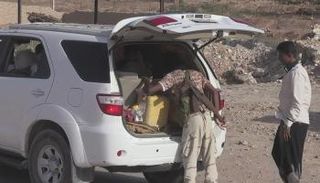 عنصر من قوات النخبة الشبوانية خلال تفتيش إحدى السيارات