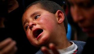 طفل سوري لاجئ هربا من القصف والمعارك