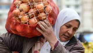 تركية تحمل جوالا مملوءا بالبصل - أرشيف