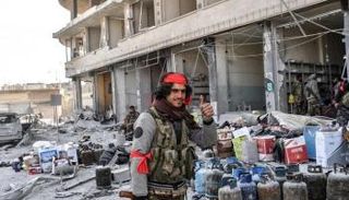 عنصر من مليشيا موالية لتركيا خلال سرقة متاجر في عفرين