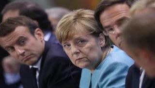 ماكرون وميركل خلال القمة الأوروبية بشأن الهجرة