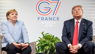 ترامب وميركل خلال اجتماع على هامش قمة مجموعة السبع