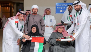 توزيع أعلام السعودية والبحرين على المسافرين