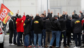 عمال شركة النفط الفرنسية توتال يتجمعون أمام مصفاة النفط في دونجس - رويترز