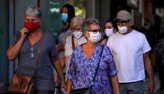 مارة يرتدون كمامات للوقاية من كورونا