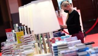 أحد موظفي معرض الكتاب في فرانكفورت ينجز آخر التحضيرات قبل المؤتمر الصحفي