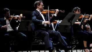 العازف رينو كابيسو يعزف مقطوعة "ميتامورفوزن" لشتراوس خلال الحفل