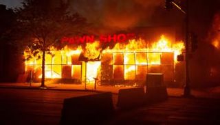 متجر مشتعل خلال أعمال الشغب في مينيابوليس- أرشيفية