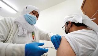 رجل يتلقى لقاح كورونا في الإمارات