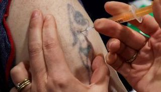 رجل بريطاني يتلقى اللقاح للوقاية من فيروس كورونا