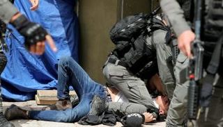 جندي إسرائيلي يجثم على صدر فتى فلسطيني في القدس