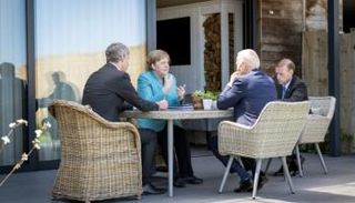 ميركل وبايدن خلال لقاء سابق - رويترز