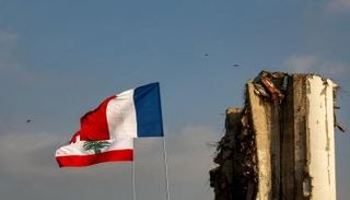 علما فرنسا ولبنان بالقرب من صوامع الحبوب المدمرة في مرفأ بيروت