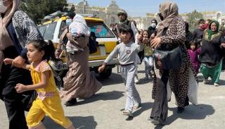 نساء أفغانيات يحاولن الهروب مع أطفالهن إلى مطار كابول 