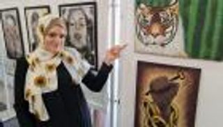 بالصور.. "متجذرون في أرض الزيتون" معرض فني يحاكي هموم شباب فلسطين