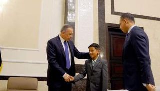 الكاظمي خلال استقباله الطفل الأيزيدي حاجم خيري