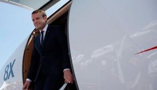 ماكرون يترجل من الطائرة في جولة خارجية سابقة