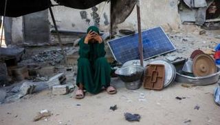 فلسطينية وسط أنقاض منزلها المدمر في خان يونس