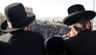 رجال من الحريديم ينظرون إلى الحشود في المظاهرة