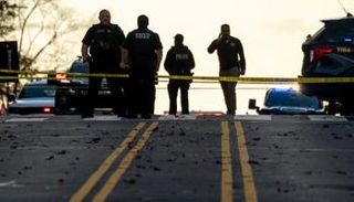 رجال الشرطة الأمريكية قرب موقع الحادث - أ.ف.ب