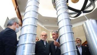 الرئيس بزشكيان (وسط-يسار) ورئيس منظمة الطاقة الذرية الإيرانية بطهران