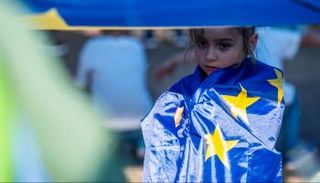 طفلة ملتحفة بعلم الاتحاد الأوروبي في انتخابات رومانيا