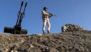 جندي إيراني على تلة يراقب الأوضاع الأمنية - أرشيفية