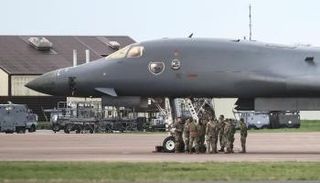 جنود أمريكيون يقفون بجوار قاذفة قنابل من طراز B-1 